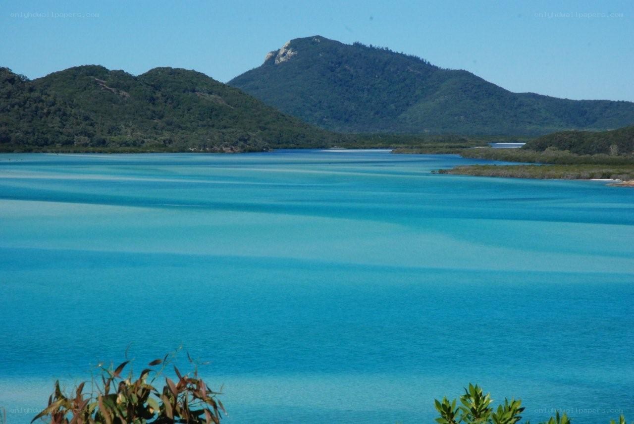 Blue waters and green hills