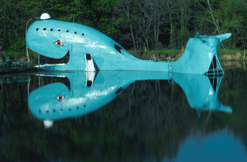 Blue whale sculpture in water