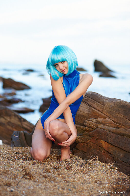 Blue-wigged woman on beach
