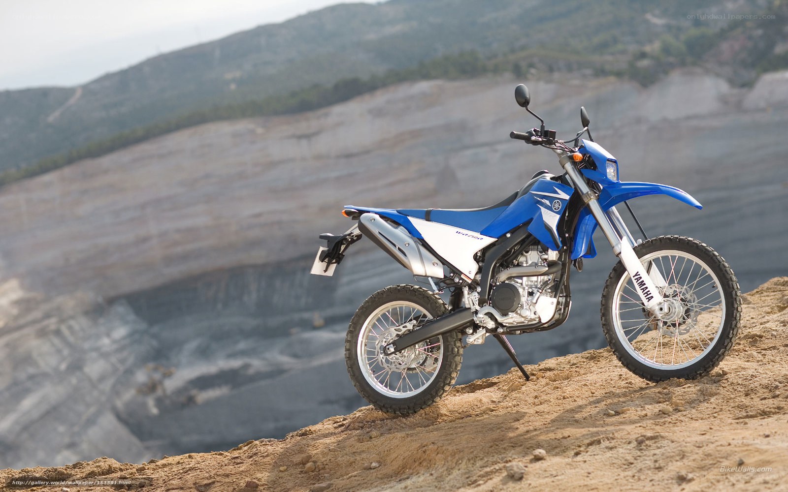 Blue Yamaha dirt bike on cliff