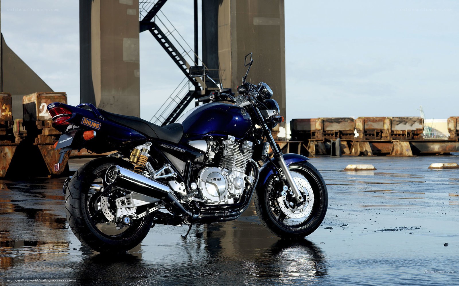 Blue Yamaha motorcycle on wet pavement