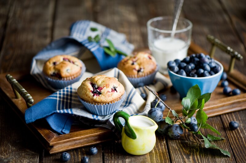 Blueberry muffins on a wooden tray