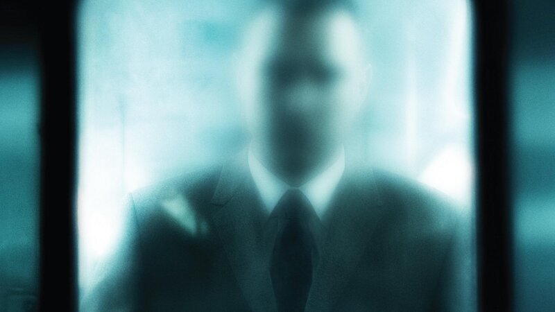 blurred figure in suit