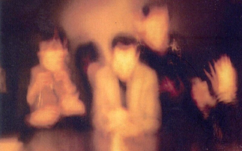 Blurred Figures in Dark Room