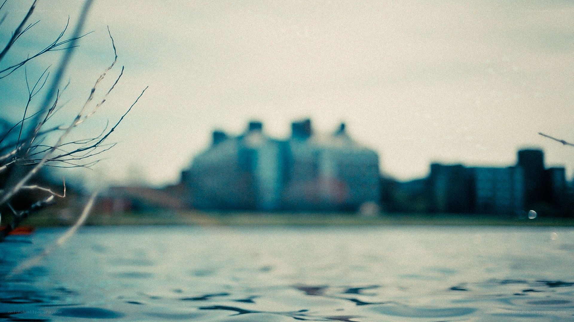 blurry cityscape by water