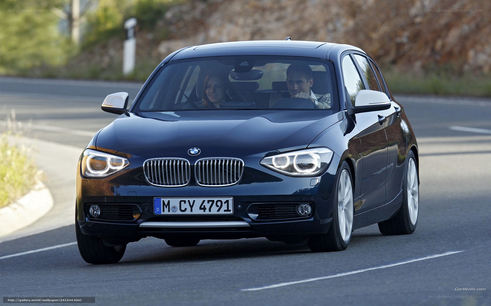 BMW 1 Series driving on road