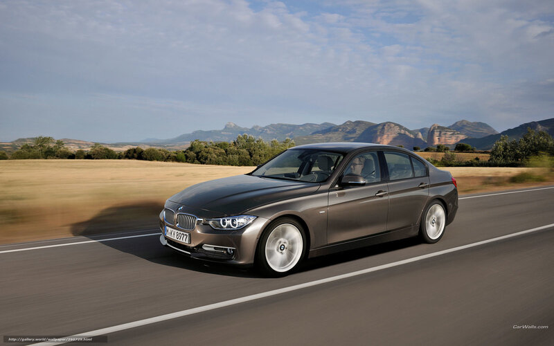 BMW 3 Series driving on a scenic road