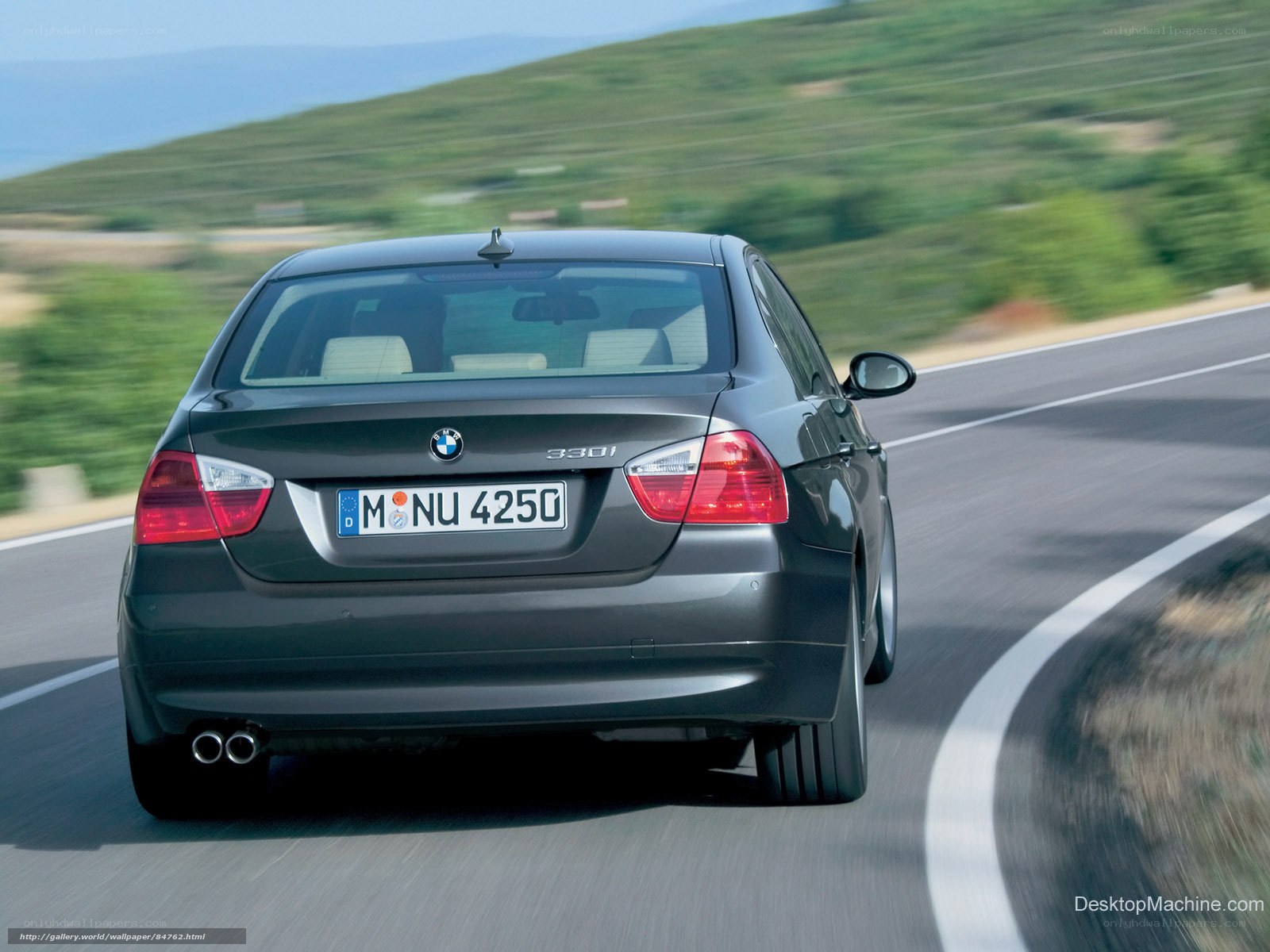 BMW 330i driving on road