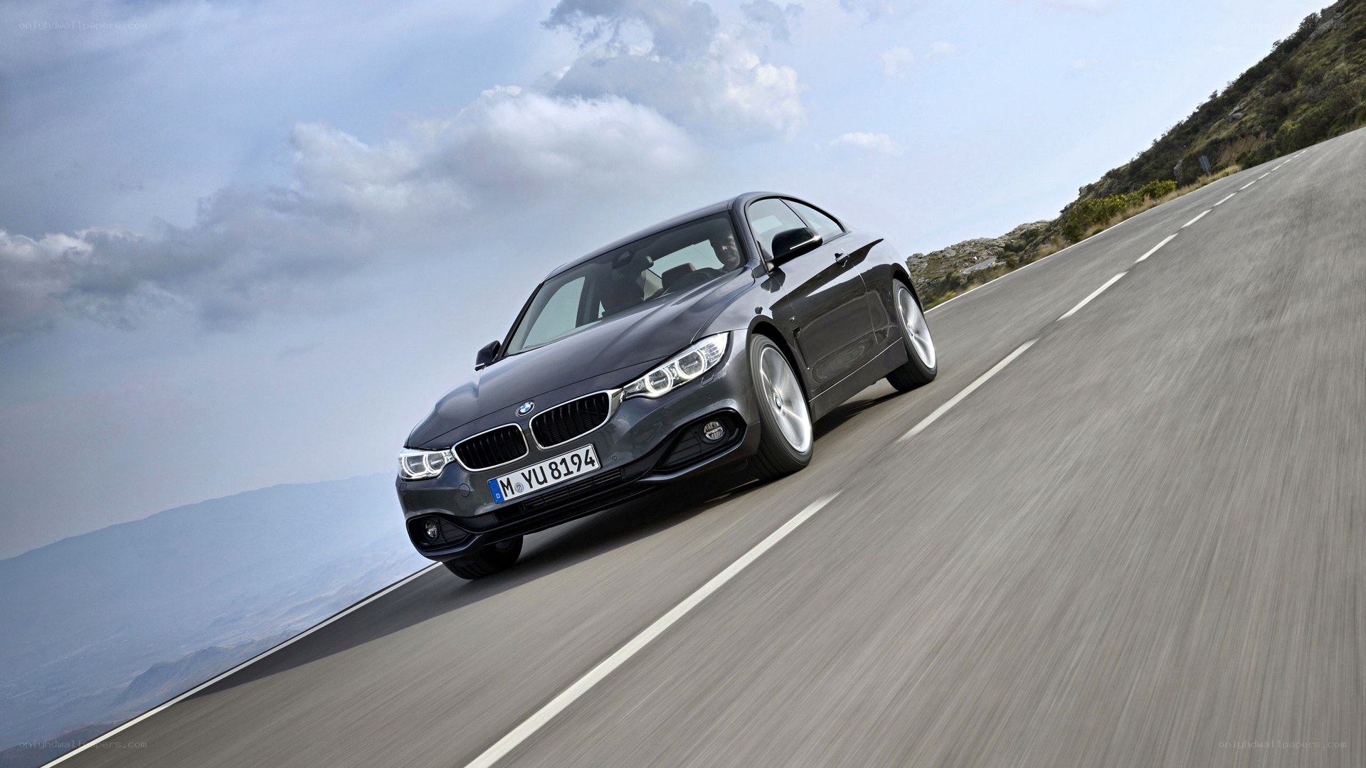BMW 4 Series driving on mountain road