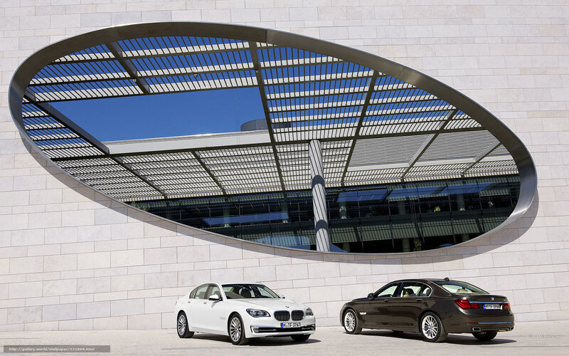 BMW 7 Series cars at modern building