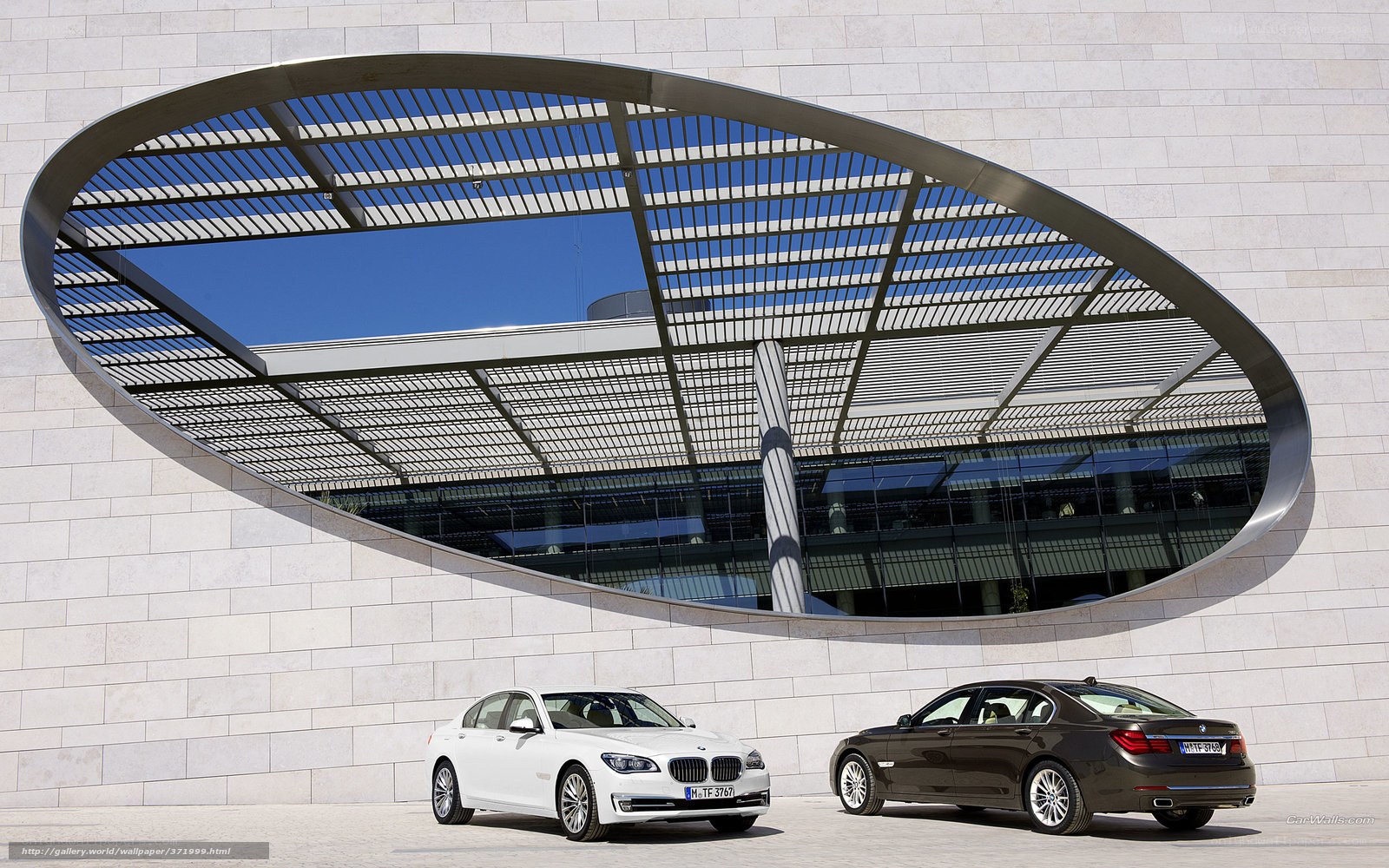 BMW 7 Series cars at modern building