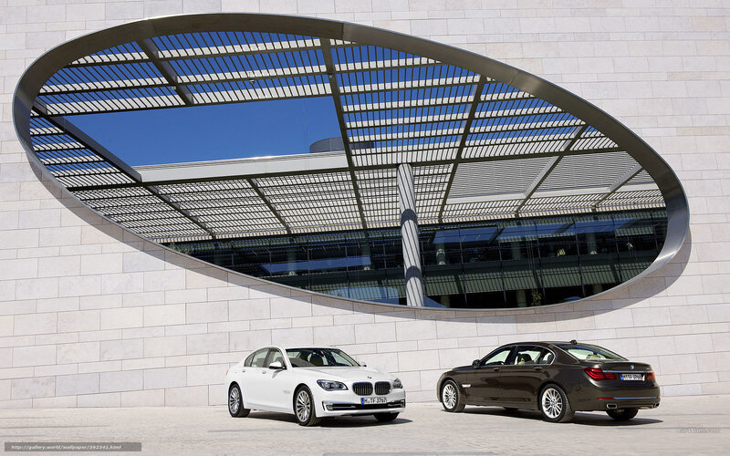 BMW 7 Series cars in front of modern building