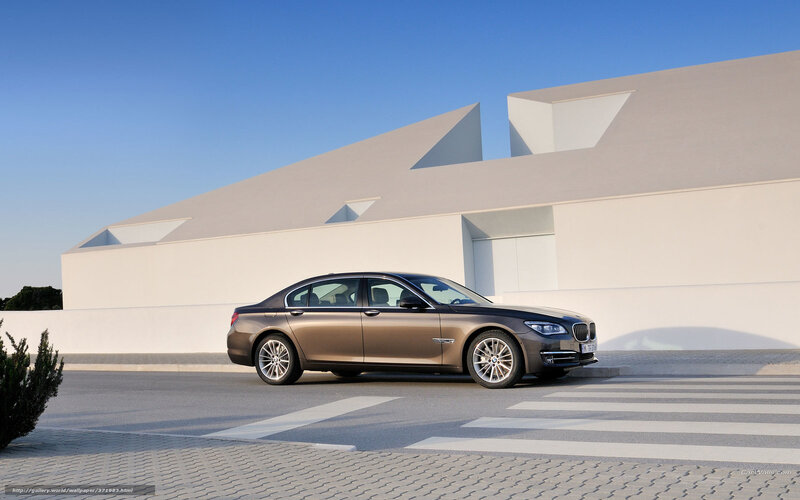 BMW 7 Series parked in front of modern building