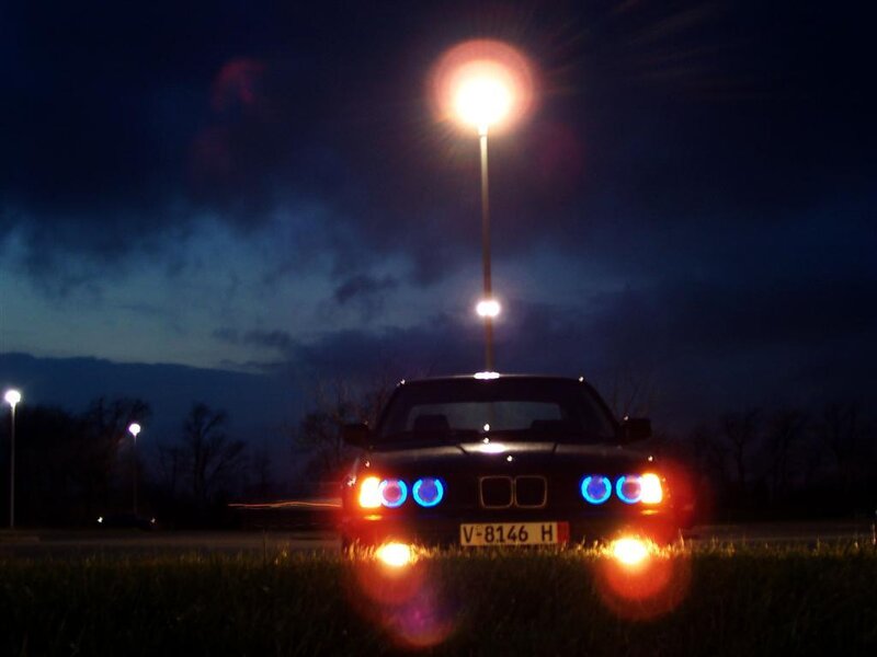 BMW at night with blue headlights