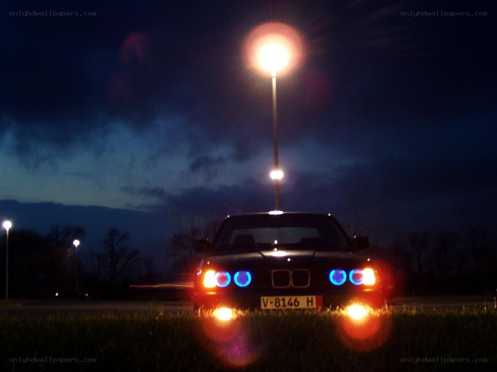 BMW at night with blue headlights