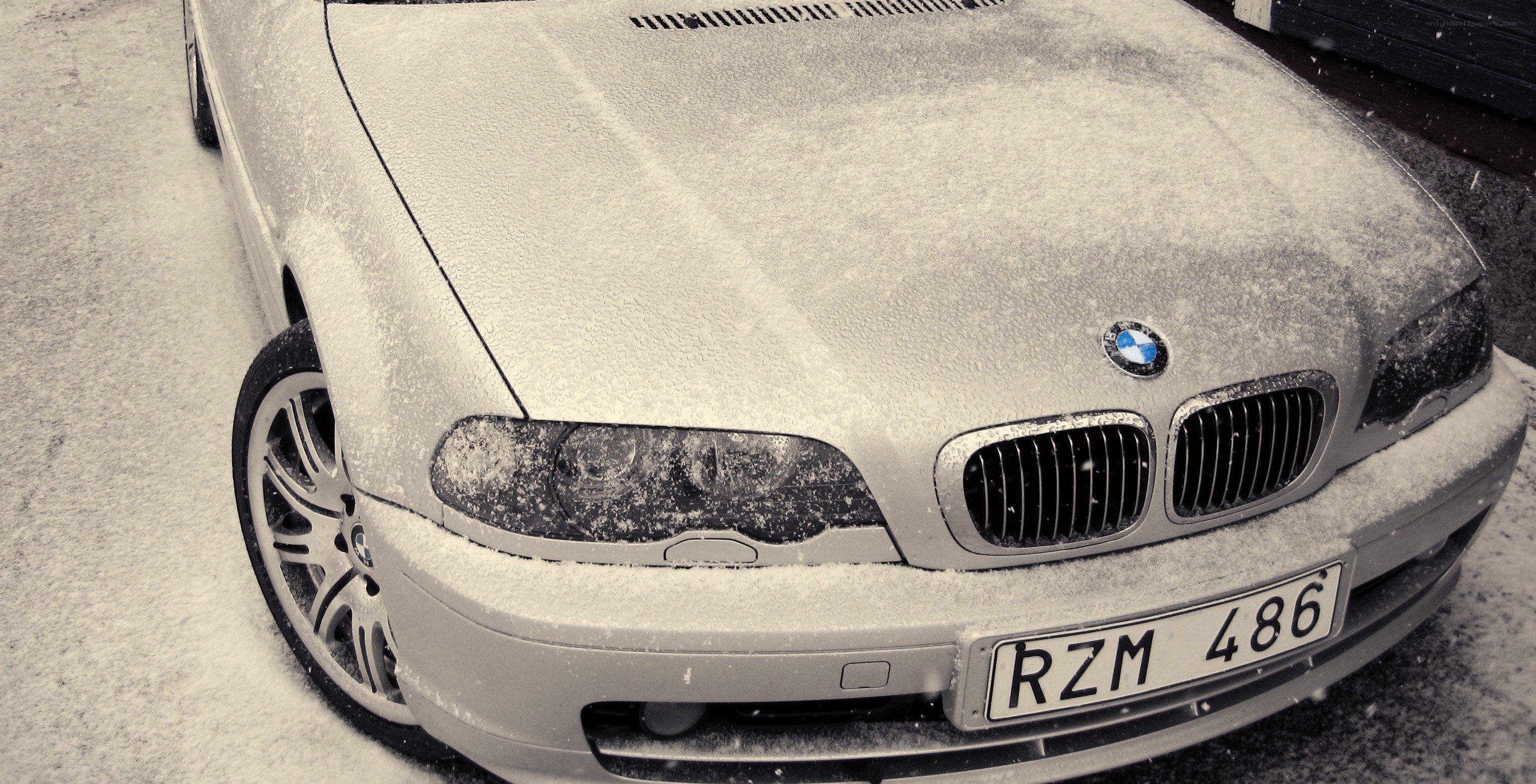 BMW car covered in snow