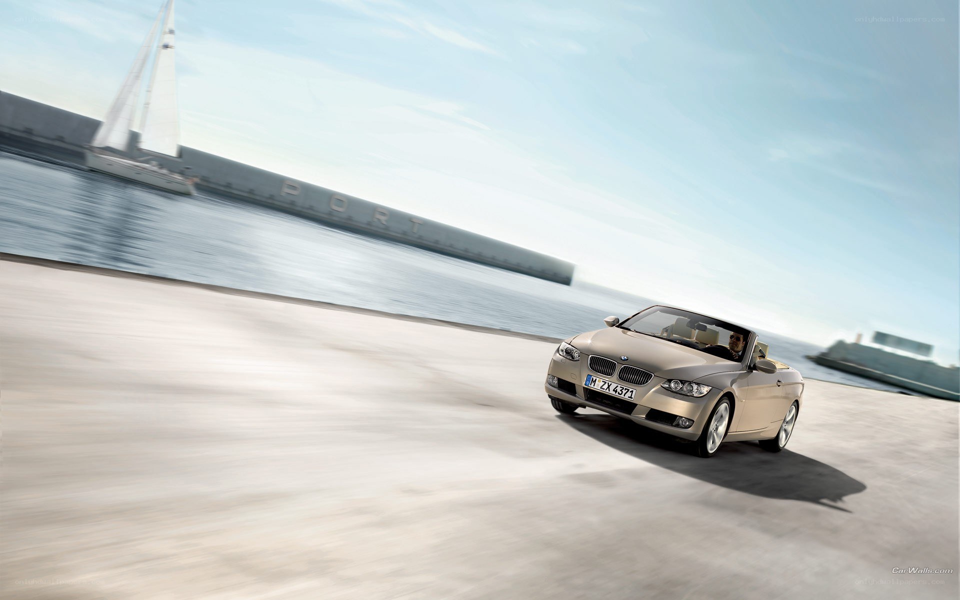 BMW convertible driving by the port