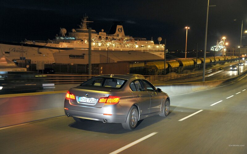 BMW driving at night near port