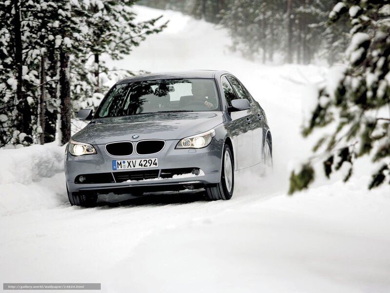 BMW driving on snowy road