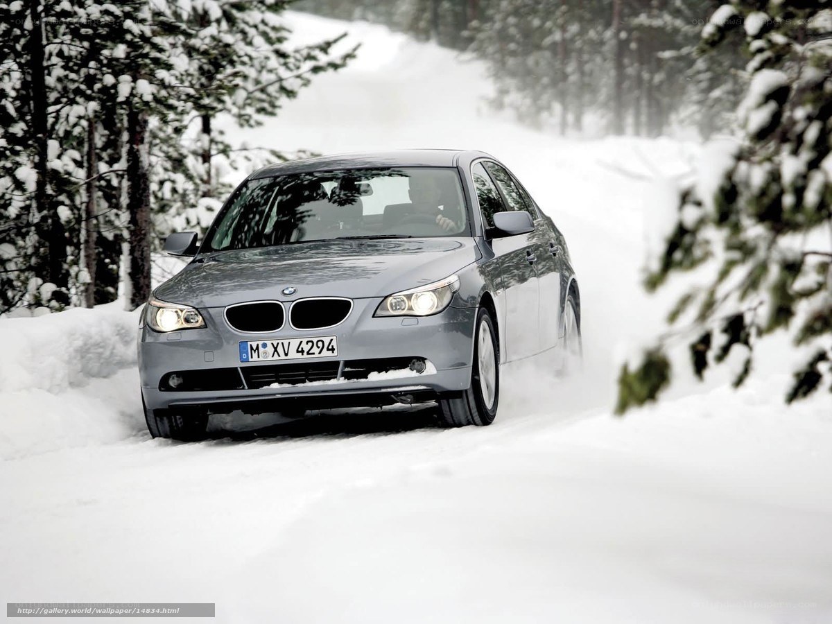 BMW driving on snowy road