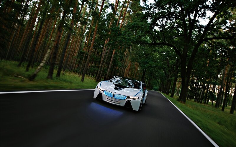 BMW i8 driving through forest