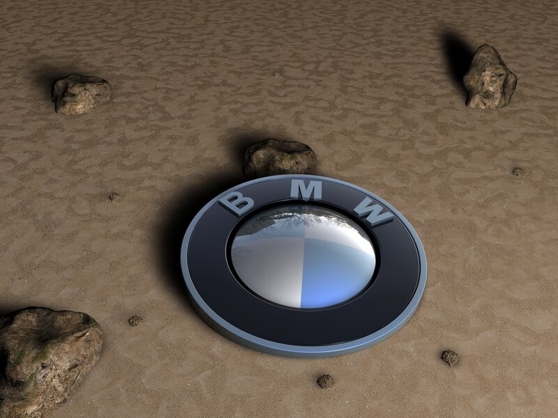 BMW logo on sandy ground