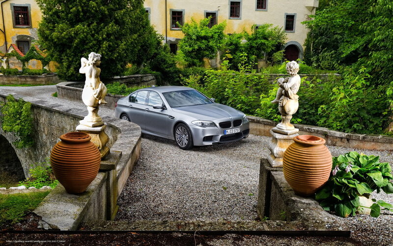 BMW M5 in a garden courtyard