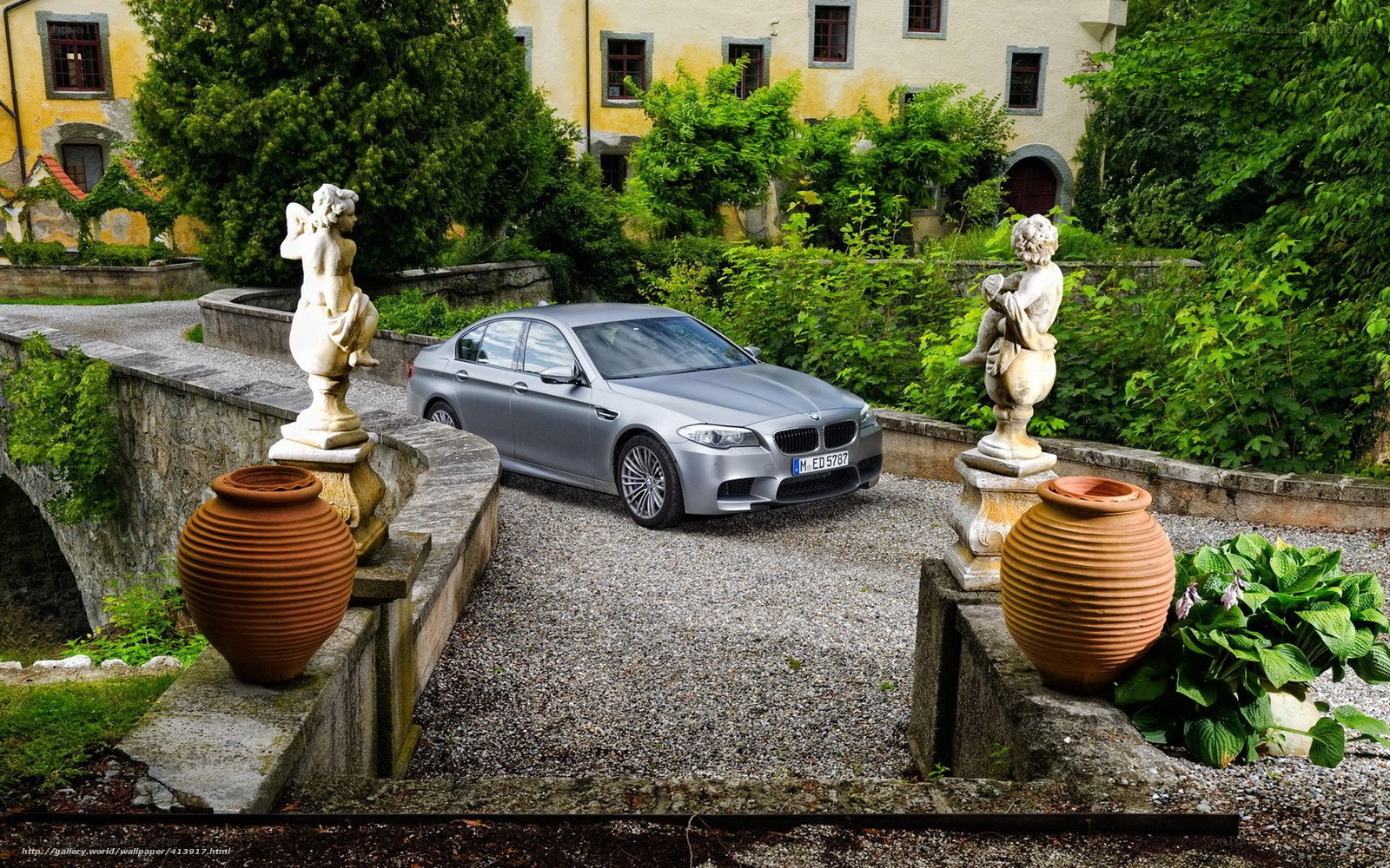 BMW M5 in a garden courtyard