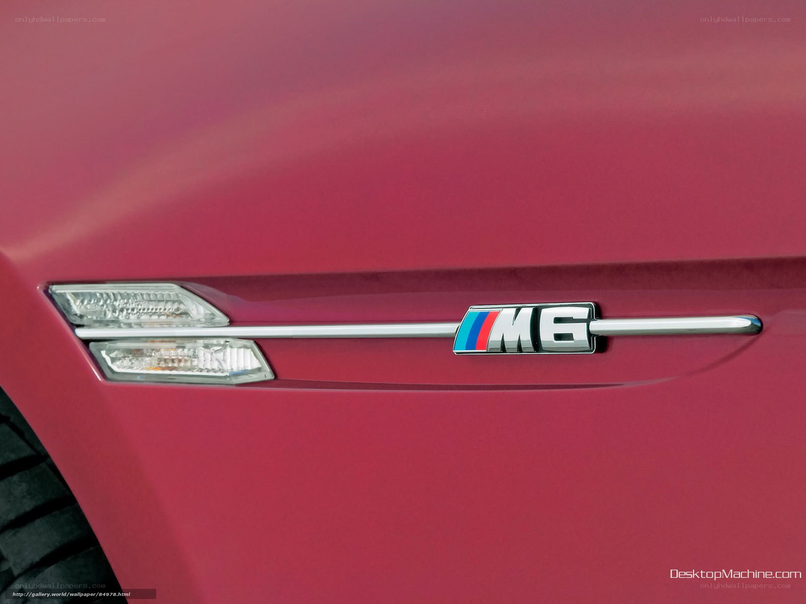 BMW M6 badge on red car