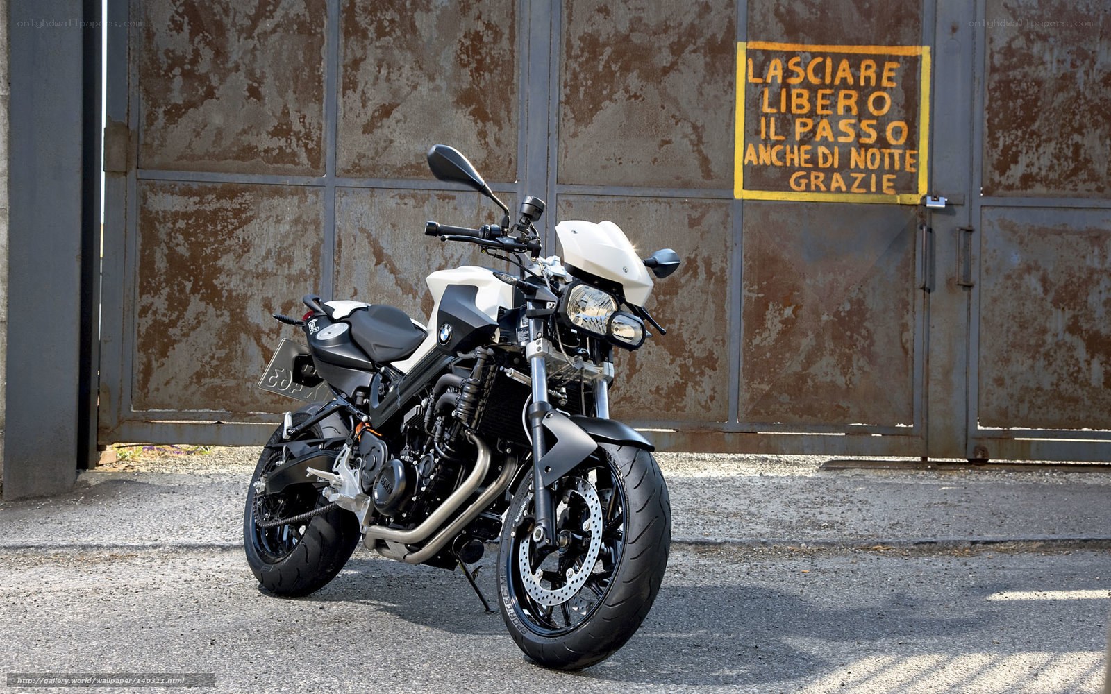 BMW motorcycle in front of gate