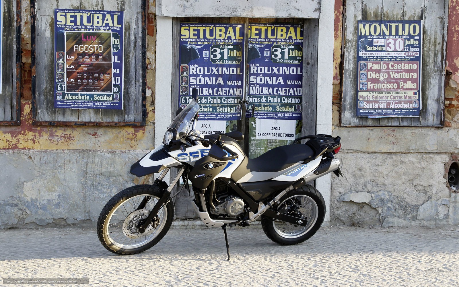 BMW motorcycle parked in front of posters