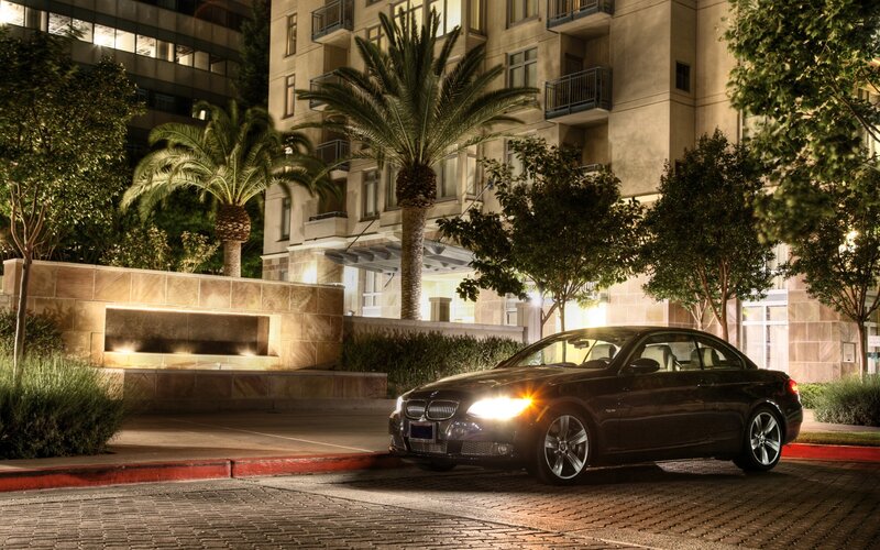 BMW parked at night near building