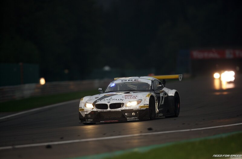 BMW race car on track at night