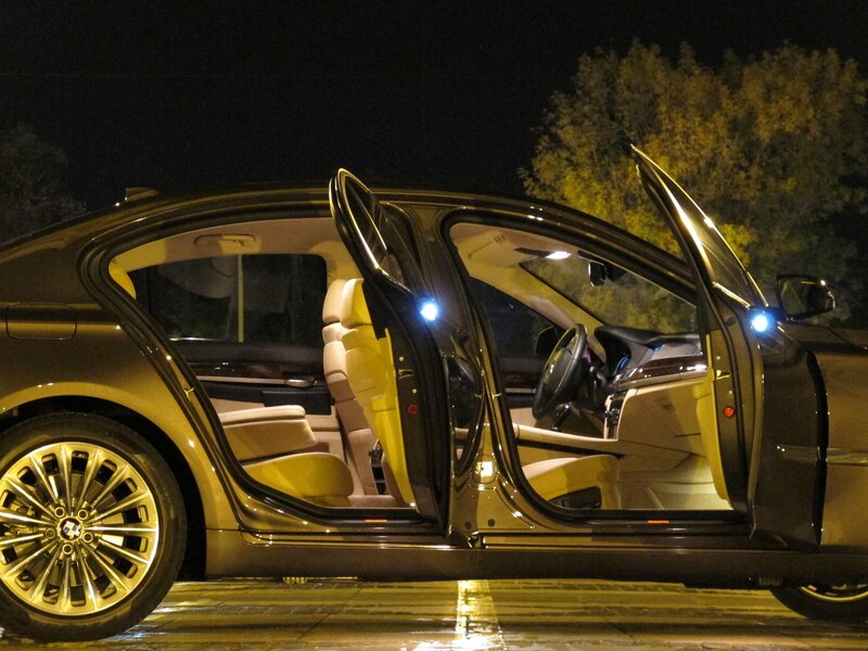 BMW sedan with open doors at night