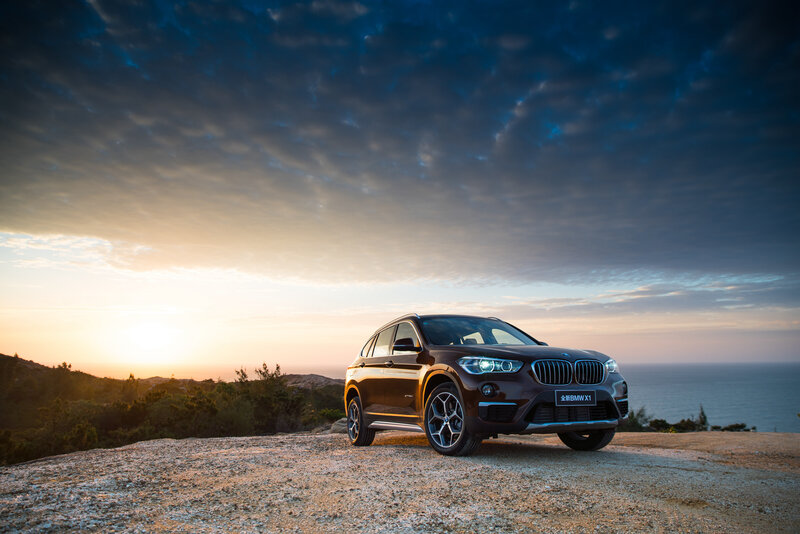 BMW X1 at sunset by the sea