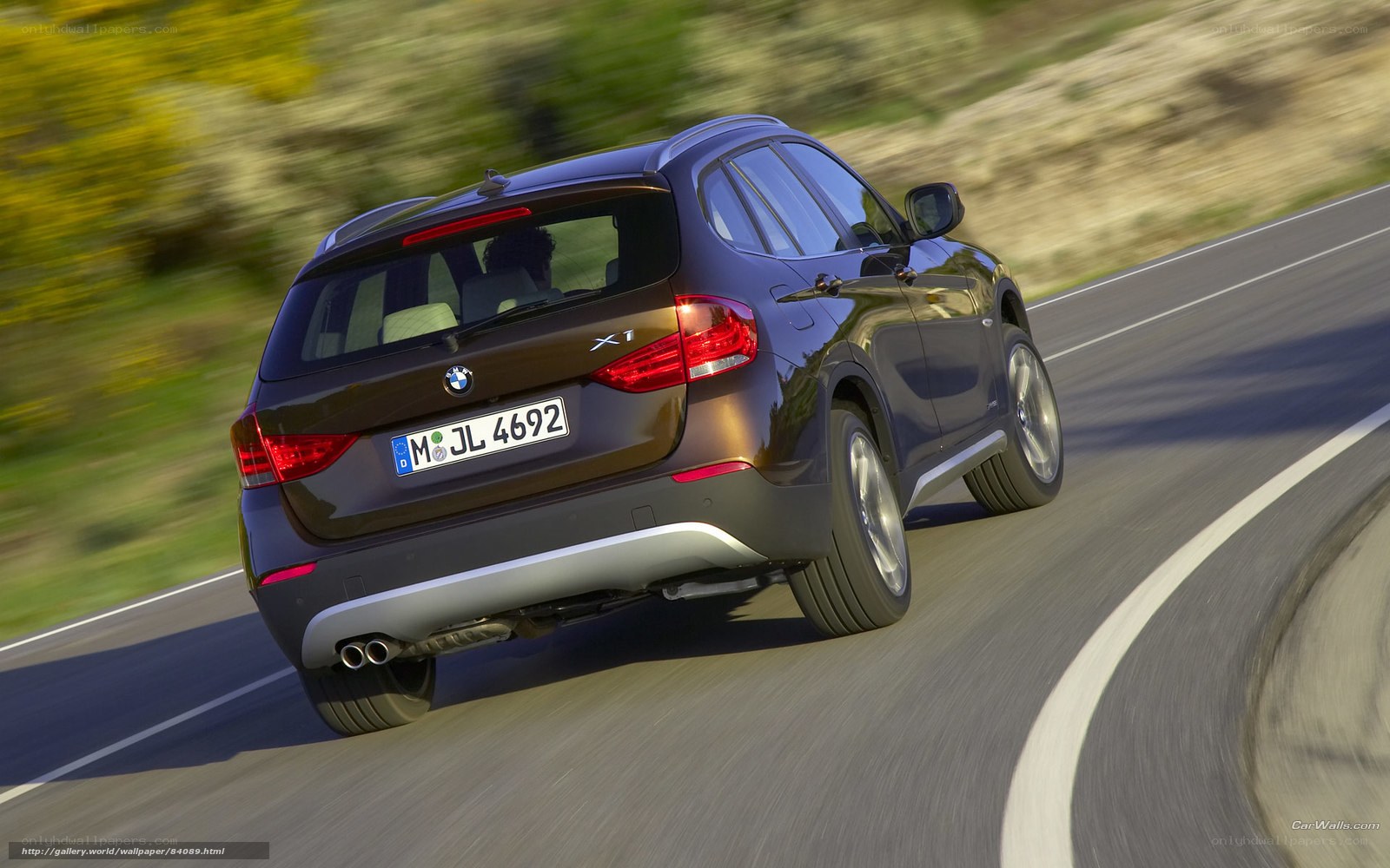 BMW X1 driving on a road