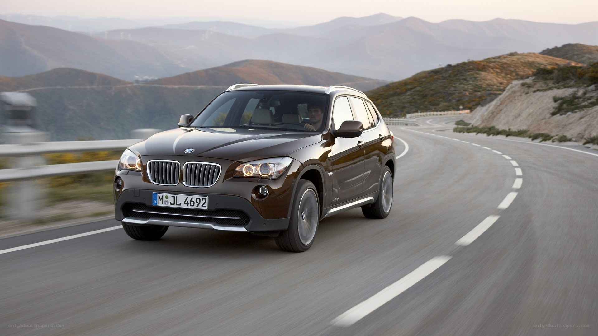 BMW X1 driving on mountain road