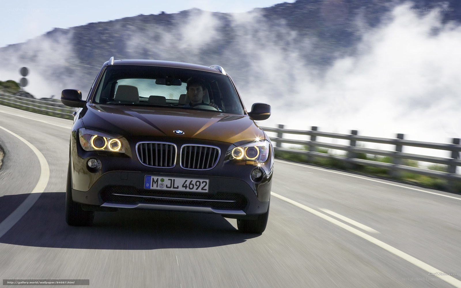 BMW X1 driving on mountain road