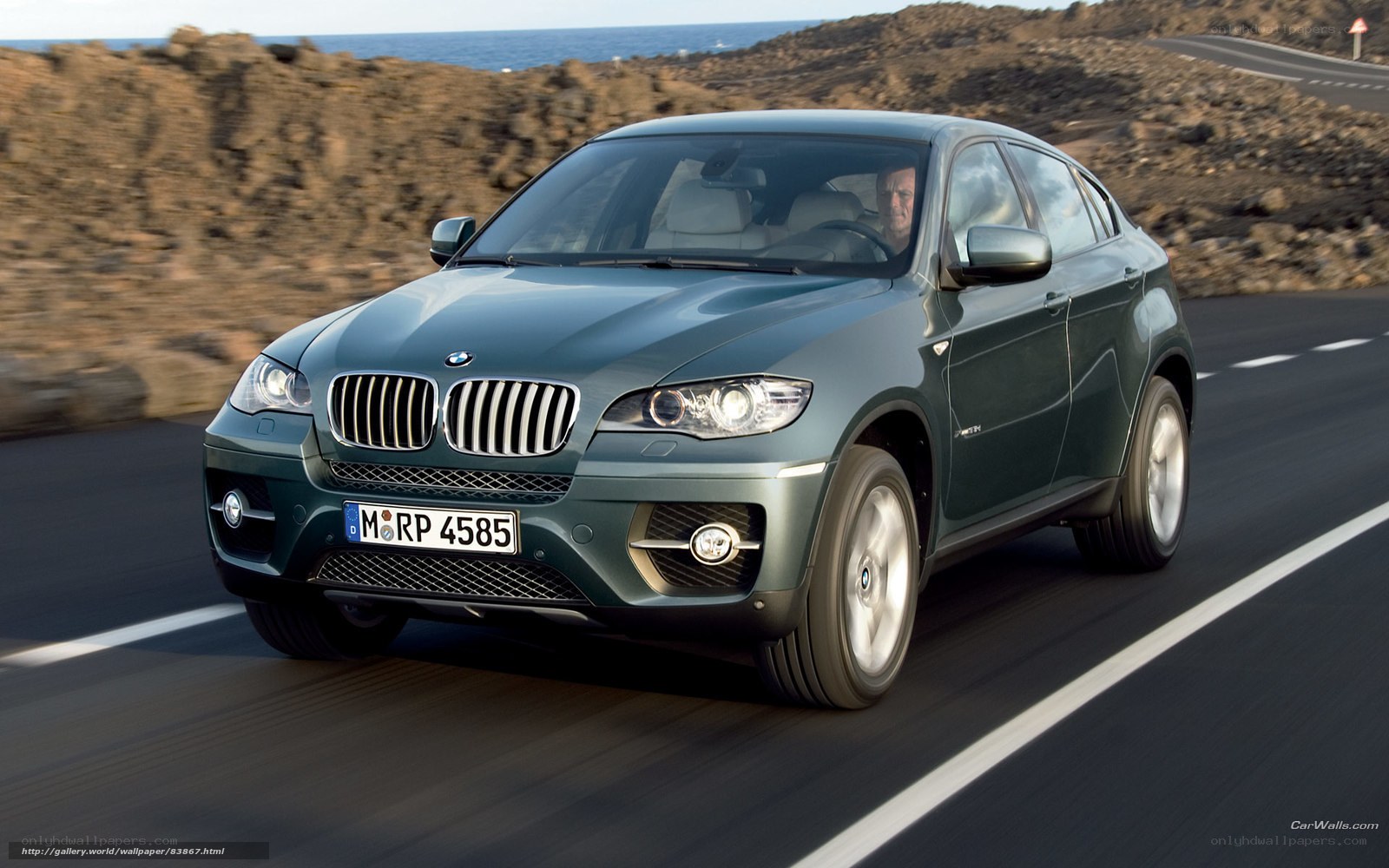 BMW X6 driving on coastal road