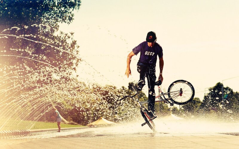BMX rider in fountain spray