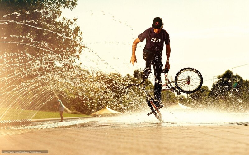 BMX rider in water spray