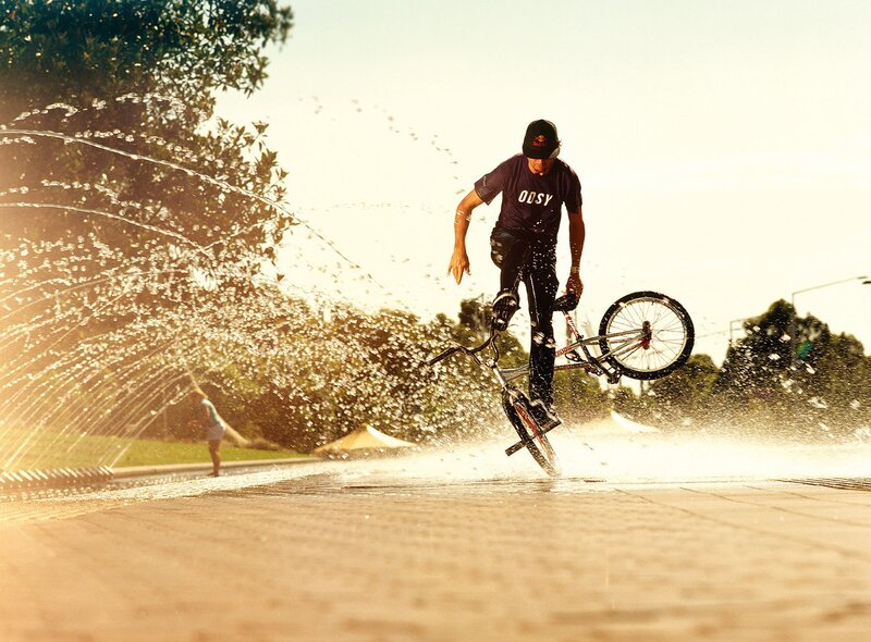 BMX rider in water spray
