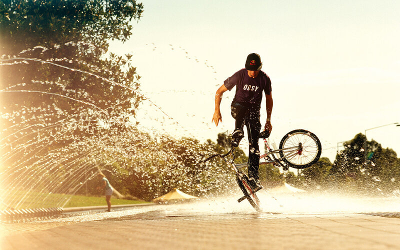 BMX rider in water spray