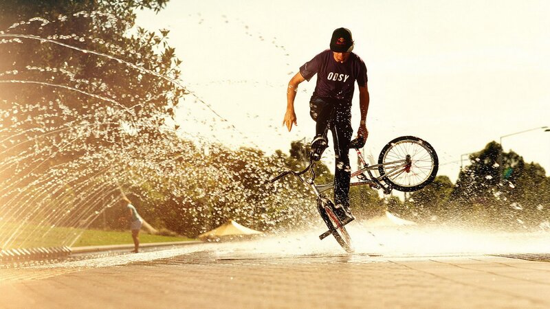 BMX rider in water spray