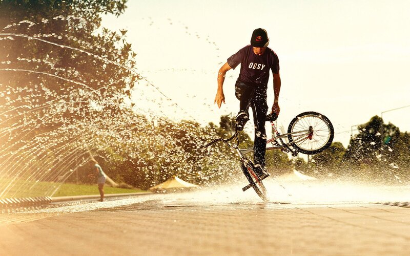 BMX rider in water spray