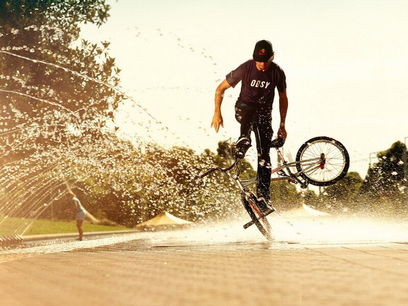 BMX rider in water spray