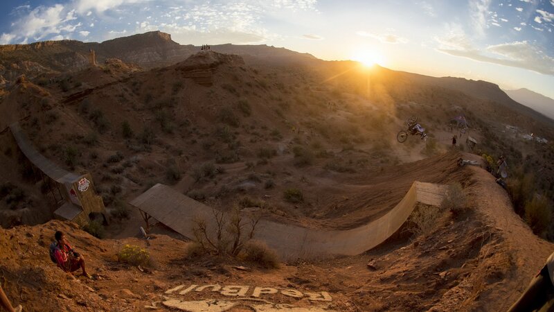 BMX rider mid-air at sunset