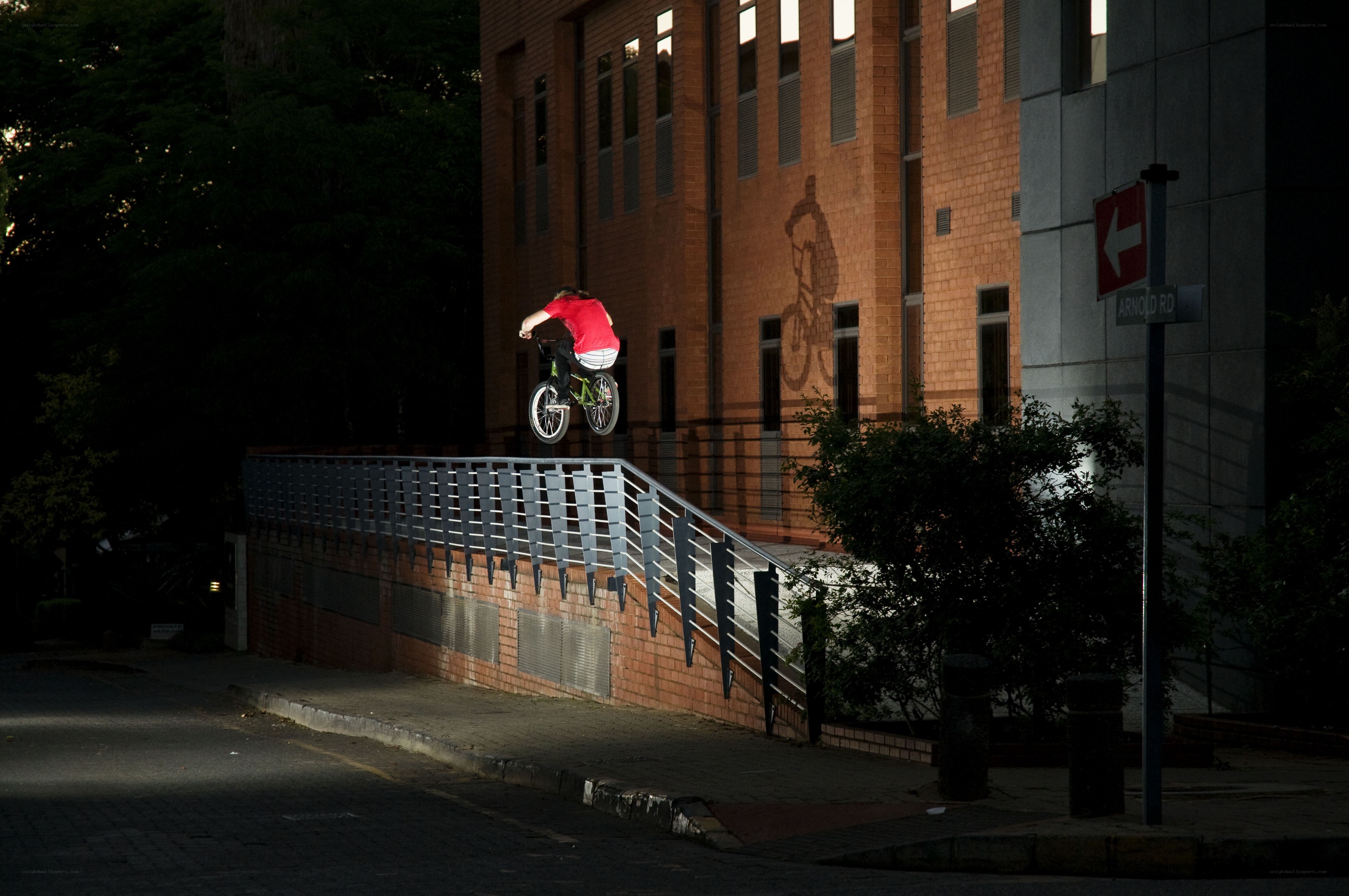 BMX rider on rail at night