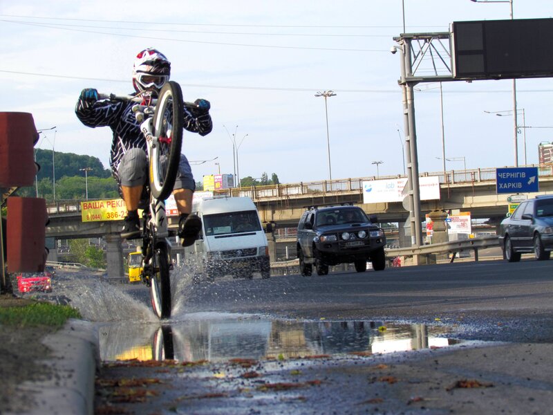 BMX rider on wet road