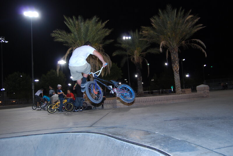 BMX rider performing trick at night